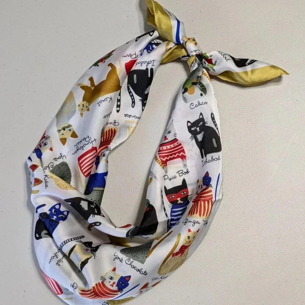 Assorted colorful whimsical cats on white background with gold trim scarf